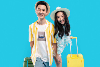 快乐的青年情侣手牵手拉着行李箱去旅游美丽的氛围相片
