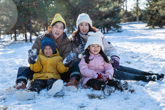 快乐的一家人坐在雪地上冬天清晰素材
