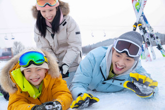 快乐的一家三口在雪地上玩雪冬天写实拍摄