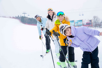 滑雪场内站一排滑雪的快乐家庭滑雪高清相片