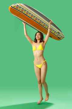 穿比基尼的美女举着冲浪板