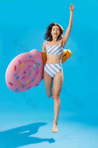 抱着冰淇淋形状的浮排跳跃的比基尼美女泳装高清场景