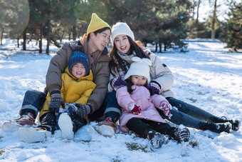 快乐的一家人坐在<strong>雪地</strong>上兴奋高端照片