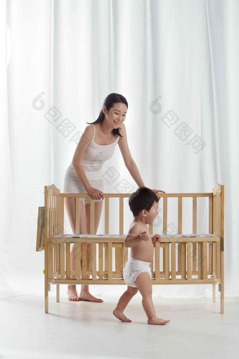 妈妈和宝宝玩耍婴儿床高清摄影图