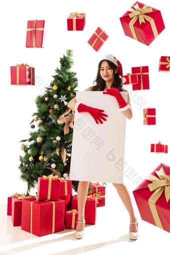 过圣诞节的年轻女人拿着白板享乐写实素材