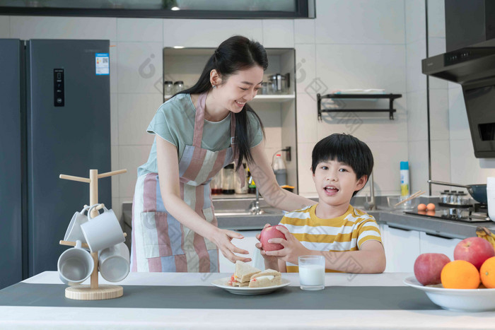 年轻妈妈给孩子做早餐准备食物高清相片家庭早餐