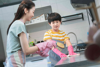 年轻妈妈指导儿子在厨房打扫卫生青年女人高质量摄影