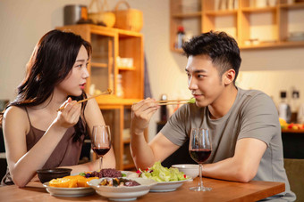 年轻夫妇用餐浪漫玻璃杯温馨摄影图
