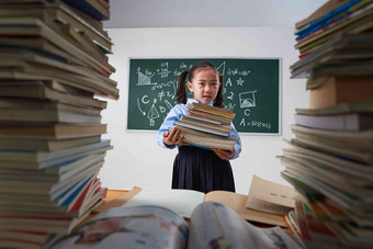 搬着沉重课本的小学女生刻苦高质量场景