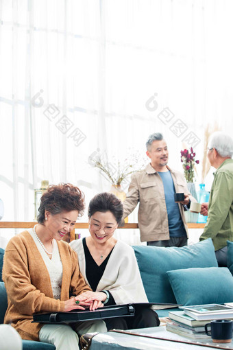 快乐的中老年人们喝茶聊天看相册
