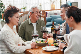 快乐的中老年朋友边吃饭边聊天社交氛围拍摄