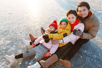 快乐的一家四口坐在冰面上玩耍温馨清晰摄影