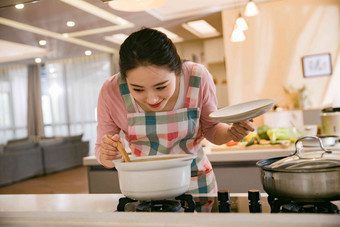 青年女人在厨房煲汤活力高端图片