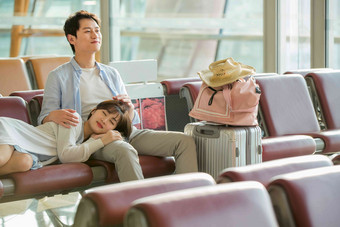 青年情侣坐在机场候机厅中国人写实镜头