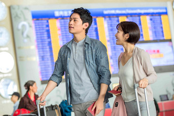 青年情侣在机场候机厅旅行者高清摄影图