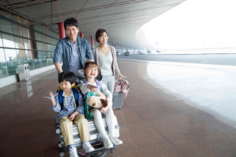 欢乐家庭在机场推着行李彩色图片氛围素材