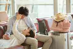 青年情侣坐在机场候机厅仰卧高端影相