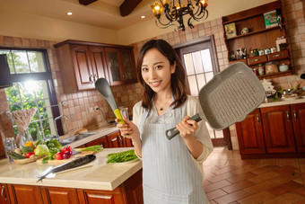 青年女人在厨房里做饭中国影相