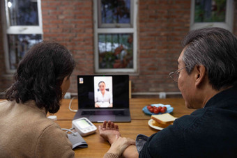 老年夫妇使用笔记本电脑在线看医生中国人写实拍摄