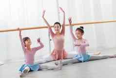 年轻舞蹈老师教小女孩们跳舞