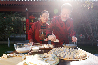 幸福的老年夫妇过年包饺子冬天场景