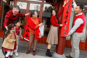 幸福的大家庭贴春联庆祝新年