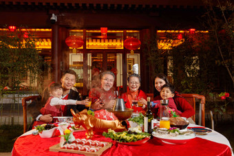 东方家庭在中式庭院内干杯庆祝新年