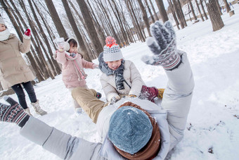 雪地里打雪仗的快乐家庭躺着高清拍摄