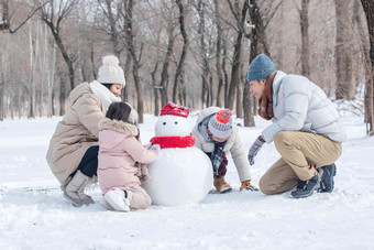 欢乐家庭在雪地里<strong>堆雪人</strong>