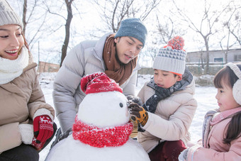 欢乐家庭在雪地里<strong>堆雪人</strong>