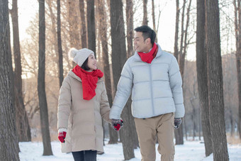 雪地上散步的青年夫妇摄影写实图片