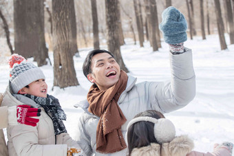 雪地里玩耍的一家人女儿氛围摄影图