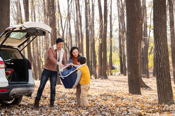 秋天户外郊游的幸福家庭一起在卸行李篮子高清拍摄