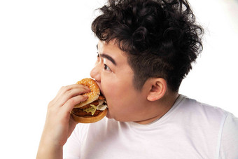 小胖子吃汉堡包身体关注高端相片