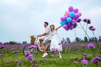 浪漫夫妇在花海里骑车成年人写实镜头