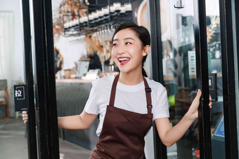 咖啡店门口迎接顾客的女服务员