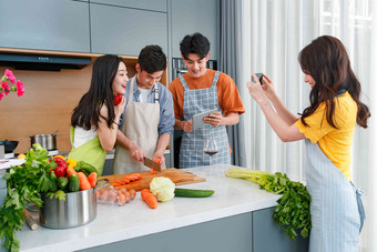 快乐的年轻人在厨房做饭照相