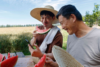 农民在田地旁休息吃西瓜种植高质量素材