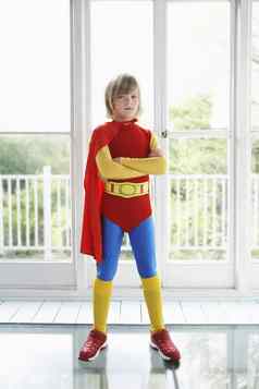 完整的长度肖像年轻的男孩超级英雄服装在室内