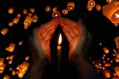 蜡烛光手浮动灯笼祈祷概念