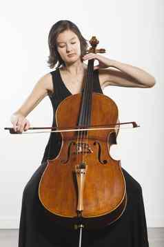 美丽的年轻的女人玩大提琴经典音乐仪器
