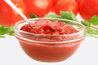 番茄酱玻璃菜背景红色的Tomatos