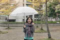 快乐微笑亚洲女人持有伞