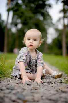 伤心婴儿女孩坐着小巷石头