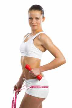 年轻的运动女人测量腰