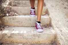 赤腿红色的运动鞋走楼梯