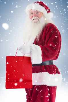 圣诞老人携带红色的礼物袋