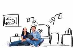 复合图像年轻的夫妇坐着地板上平板电脑