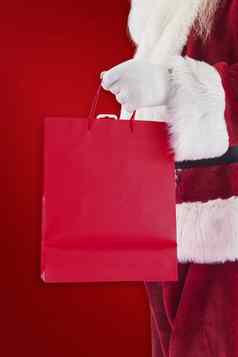 复合图像圣诞老人携带红色的礼物袋
