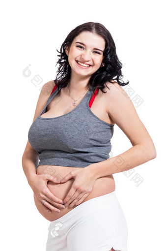 年轻的怀孕了女人使心手势